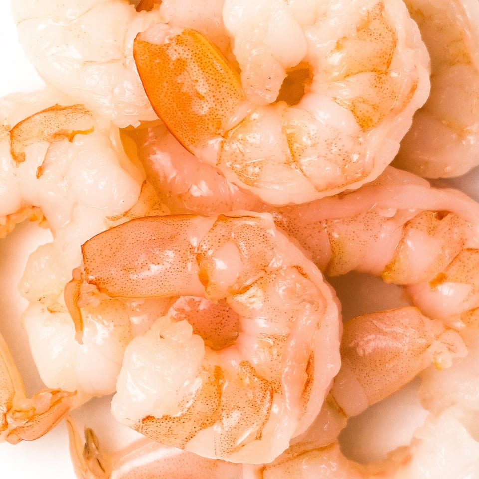 Close-up of several pink and orange cooked shrimp, perfect for a POKÉ + GO poke bowl.