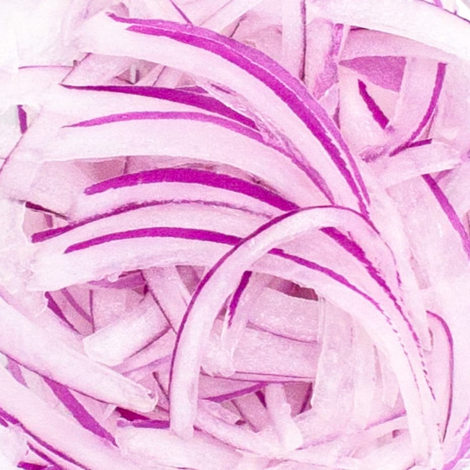 Close-up of thinly sliced red onions, a common topping for POKÉ + GO's poke bowls.