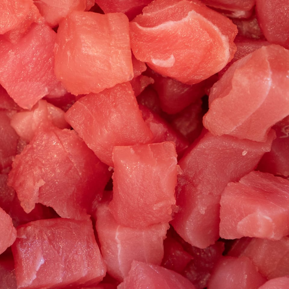 Close-up of fresh, diced red tuna, ready for a POKÉ + GO poke bowl.