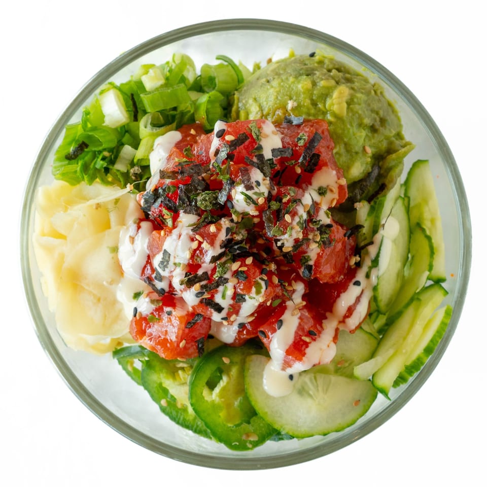 Overhead view of a POKÉ + GO poke bowl with tuna, avocado, cucumber, and ginger.